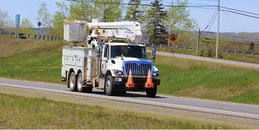 Electrical Truck driving down a road
